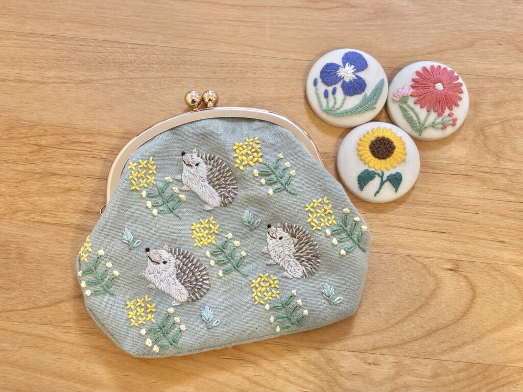 刺繍したがま口とブローチの写真